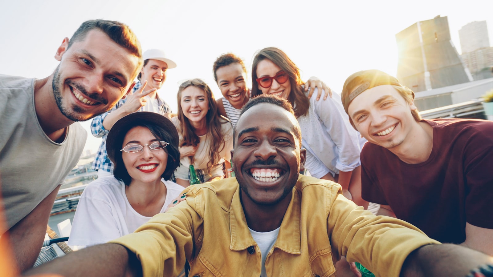 A diverse group of friends together outdoors, smiling